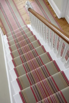 the stairs are lined with striped rugs