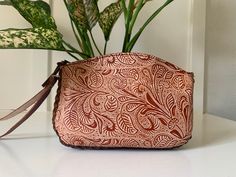 Beautiful Hand Tooled Embossed Leather Floral Wristlet. Genuine Mexican Leather, Made in Mexico using the Cincelada technique. Dimensions: 7.5" x 5.5" Imported from Mexico, they are a continuation of the fine craftsmanship established in that country going back hundreds of years with carved leather saddles. These beauties are not like the more common stamped products that can be mass produced cheaply and sold. Each piece is hand-cut by skilled artisans in leather carving, preserving the art and tradition of a centuries old technique which is still popular today. Talk about slow fashion! All of our products are ethically sourced and 100% authentic Mexican products. Please note that the actual product color may vary from the images shown. Every monitor or mobile display has a different capab Leather Carving, Leather Floral, Beautiful Hand, Slow Fashion, Embossed Leather, Hand Tools, Purses And Handbags, Carving, Stamp