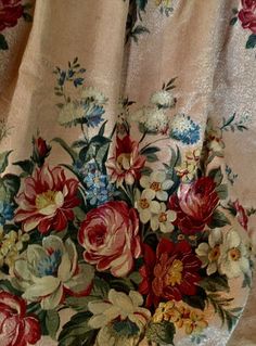 a vase filled with lots of flowers on top of a table covered in a blanket