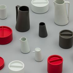 many different types of cups and saucers on a table with one cup in the middle