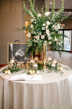 a table with flowers and candles on it