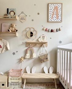 a baby's room with white walls and wooden shelves