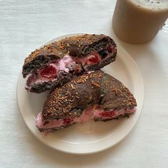 two sandwiches are on a plate next to a cup of coffee and a glass of milk