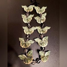 a necklace made out of dollar bills and butterflies