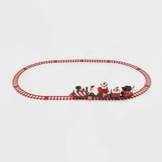 a toy train with santas riding on it's tracks in the middle of a white background