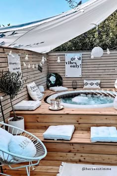 a hot tub sitting on top of a wooden deck