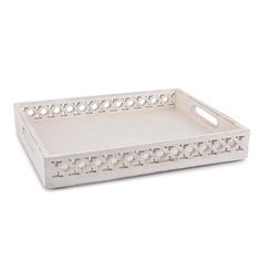 a white tray with an intricate design on the bottom and handles, sitting on a white surface