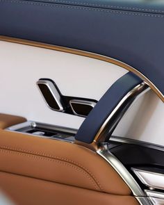 the interior of a car with leather and chrome trims, including an automatic door handle