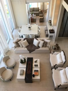 an aerial view of a living room with couches, chairs and tables in it