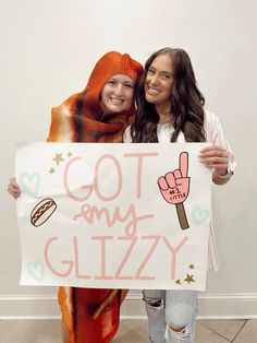 two girls holding up a sign that says, got my glazey on it