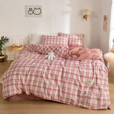 a bed with pink and white checkered sheets