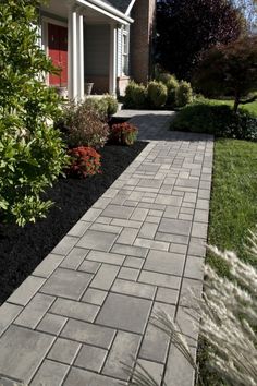 a brick walkway in front of a house