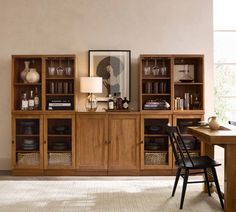 a dining room with a table and chairs next to a bookcase filled with books