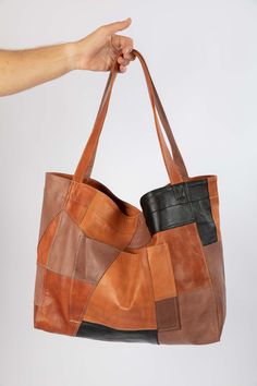 This up-cycled tote is an ode to sustainability and stand against waste. The patchwork design is entirely handmade of the remaining pieces of leather from our other items that would otherwise be disposed of. Additionally, it is a true piece of art, with each patch meticulously positioned and stitched together to create a harmonious and elegant pattern. It is incredibly durable, as any sustainable product should be, and biodegradable as the leather is 100% vegetable tanned. Made of the softest la Patchwork Leather Bag, Leather Bags Handmade Pattern, Leather Products Ideas, Art From Waste, Diy Leather Tote Bag, Diy Leather Tote, Leather Artwork, Patchwork Tote Bags, Handmade Fabric Bags