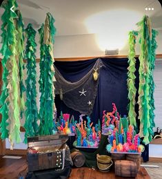 an under the sea themed birthday party with tissue streamers and paper garlands hanging from the ceiling