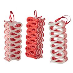 three red and white spirals hanging from strings