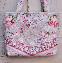 a pink and white purse with flowers on it