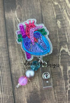 Anatomy Heart acrylic blank decorated with glitter and vinyl. This heart badge is sealed with UV resin.  This badge can be attached to an alligator swivel or belt slide clip. Badge snap will be finished with a glitter or rhinestone button. Add a beaded badge charm for additional flair. Badges are sturdy but may break if dropped or hit against a hard surface. Clean with a soft cloth and avoid harsh chemicals that will dull the shine.  Items are handmade and minor imperfections may occur. This is Dermatology Badge Reel, Resin Name Badge Reel, Resin Nurse Badge Reel, Anatomy Heart, Personalized Pink Novelty Badge Reel, Heart Anatomy, Medical Badge, Anatomical Heart