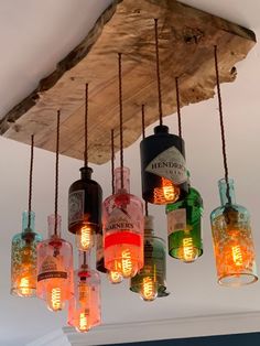 a bunch of bottles that are hanging from a ceiling