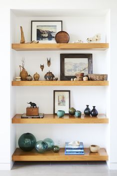 some shelves with vases and pictures on them