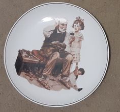 a plate with an image of a man and woman sitting on top of each other