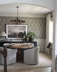 a dining room table with two chairs around it