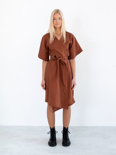 "MARY is a short sleeve robe style linen wrap dress with a self tie belt. DETAILS - Self tie belt with no closure or belt loops - Dolman style sleeves - Knee length - 100% lightweight European linen fabric - Cut and sewn to order just for you in our studio COLOR - Rust, you can also choose other colors above - Fabric samples are available here https://www.etsy.com/listing/586569696/linen-fabric-samples SIZING & FIT - Relaxed fit - True to size - Measurements taken from a size XS - Model is 5 Belted Linen Wrap Dress, Casual Linen Wrap Dress With Tie Waist, Belted Wrap Dress For Daywear, Daywear Belted Wrap Dress, Short Sleeve Wrap Dress With Tie Waist For Work, Short Sleeve Linen Dress With Tie Waist For Work, Brown Short Sleeve Dress With Tie Waist, Kimono Sleeve Dress, Wide Leg Linen Trousers