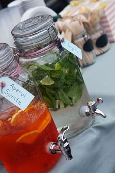 there are many jars with different types of food in them on the table and one has a name tag attached to it