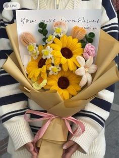 a woman holding a bouquet of flowers with a card in her hand that says, you are sunshineflowers