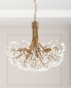 a chandelier with white flowers hanging from the ceiling