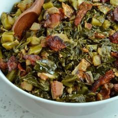 a white bowl filled with greens and bacon