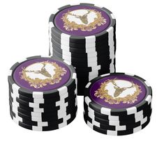 four stacks of black and white poker chips with gold designs on the top one is purple