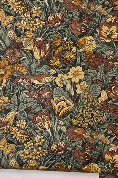 a floral wallpaper with many flowers and birds on it's side, in various colors