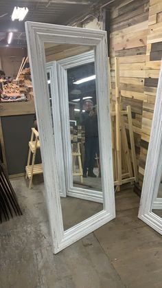 two large white mirrors sitting next to each other