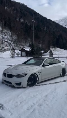 a white car is parked in the snow