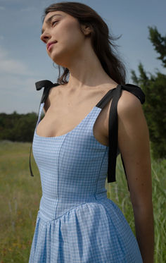 A truly special dress.  With rich black ribbon tie straps, a corset bodice, and sweeping ruffle hem the Mirabelle Dress is dramatic, romantic beauty at its best and one of our most popular styles.  Made in a lightweight blue gingham linen with a sateen finish that gives the linen a subtle dressy luster. A showstopper of a dress made for special moments, celebrations, or romantic getaways. Dream Wardrobe Aesthetic, Georgia Armani, Sierra Ferrell, Modern Bridgerton, Postpartum Wardrobe, Winter Sewing Projects, Draping Dress, Ruffle Summer Dress