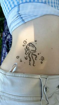 a person with a tattoo on their stomach