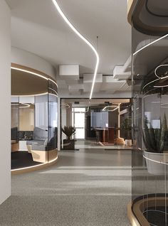 an empty office with glass walls and round planters