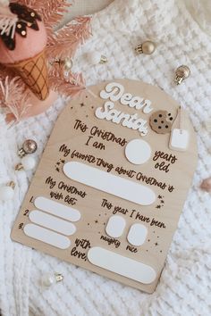 a wooden board with the words dear santa written on it