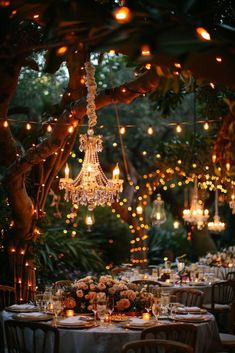 an outdoor dining area with chandeliers and tables