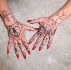 two hands that have tattoos on them and one has a heart in the middle with arrows