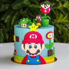 there is a cake decorated with mario and other characters