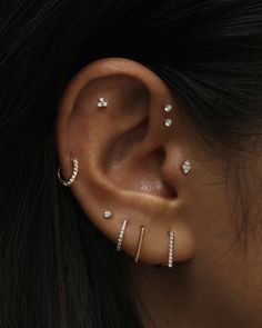 a woman with three piercings on her ear