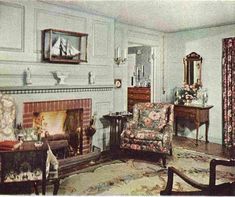 an old photo of a living room with chairs and a fire place in the corner