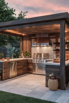 an outdoor kitchen is shown in the evening