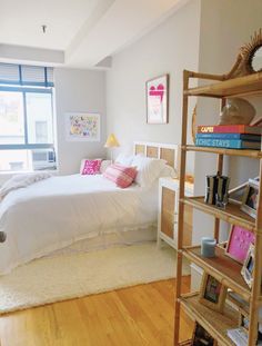 a bed room with a neatly made bed and a book shelf