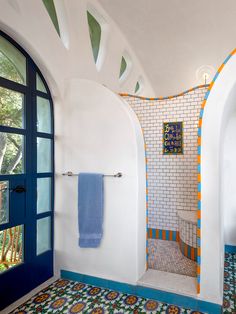 a bathroom with blue and orange tiles on the walls