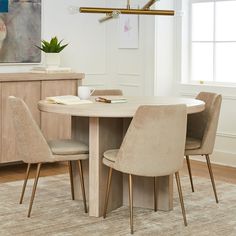 a dining room table with four chairs around it