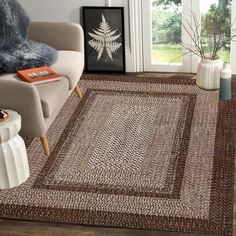 a living room with a chair and rug on the floor