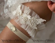 a close up of a woman's white garter with flowers on the side